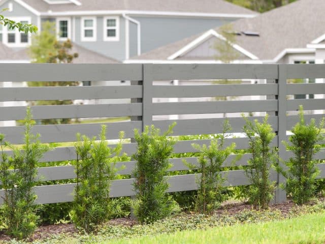 How to Love Your Gray Wood Fence Instead of Fighting It